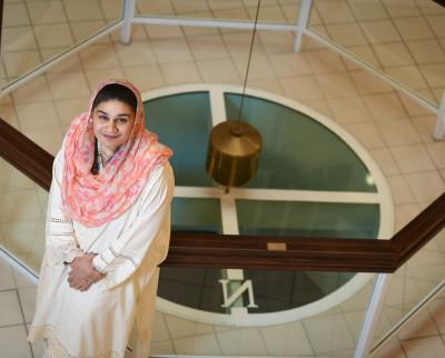 Samya Zain looking up from the pendulum in Fisher Hall